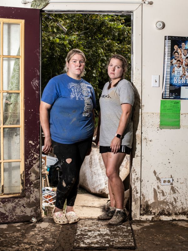 Andrea Hall (left) and Krisann Hart (right) pose for a portrait while helping clean their grandpa's home which was destroyed by floodwaters in Pine Top, K.Y., on Thursday, August 4, 2022.