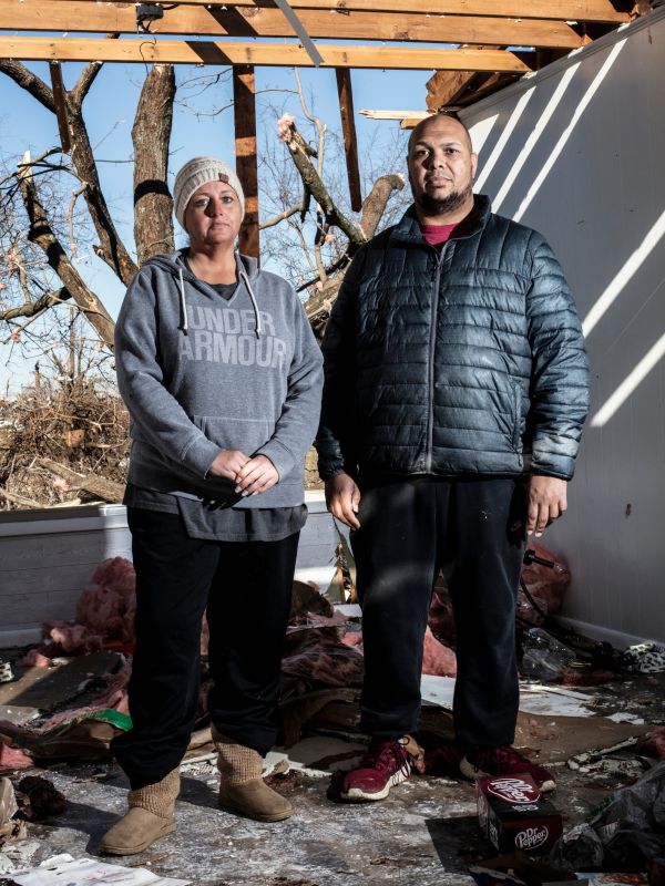 Shyanne Wilford (left) and Joe Tyler (right) pose for a portrait in their home after a tornado outbreak in Mayfield, Ky., on Sunday, December 12, 2021.