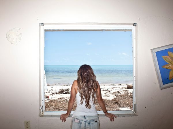 Stephanie Caldera looks out onto the Gulf of Mexico while surveying damage to her neighbor's home in Islamorada, Fla., on Wednesday, September 13, 2017.