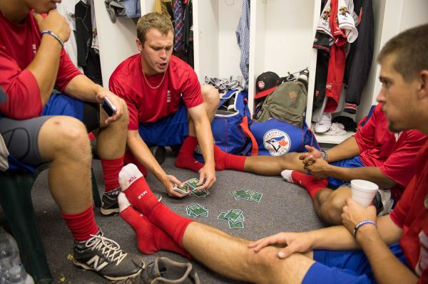 The Vancouver Canadians pitcher, Mark Biggs, deals the cards for a game of "big two", before a game in Boise, Idaho vs the Boise Hawks.