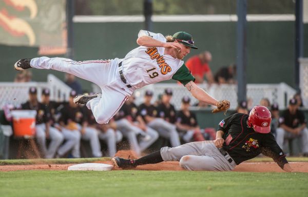 The Vancouver Canadians Tim Locastro steals third under the tag of Boise Hawks third baseman, Jesse Hodges during a game in Boise, Idaho.
