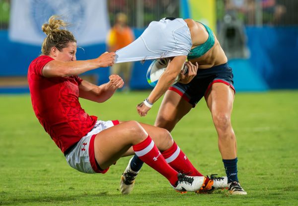 Canada's Charity Williams pulls the jersey of Great Britain's Emily Scarratt during rugby at Deodoro Stadium.