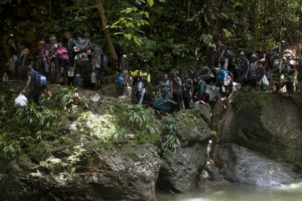 Migrants from Haiti get caught on a crevasse along the Death river, Colombia, September 8, 2021.
