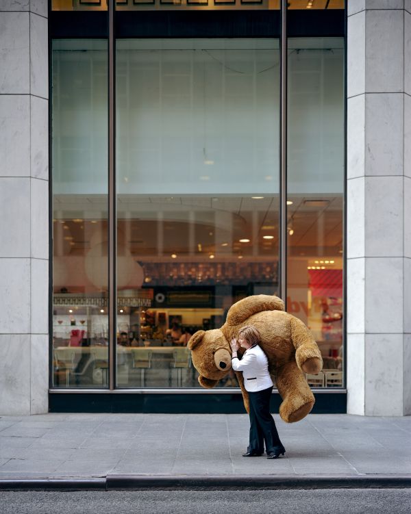 Woman Carrying a Stuffed Bear