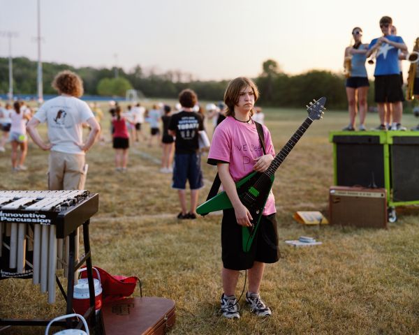 Young Man Holding a Guitar