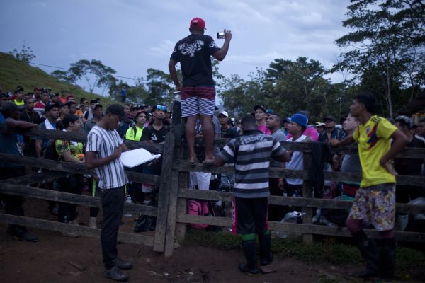 Colombian guides explain to venezuelan migrants what their are about to encounter in the Darien gap jungle, before they let them out of Las Tekas migrants camp, early in the morning, Acandi, Colombia, September 11, 2022.