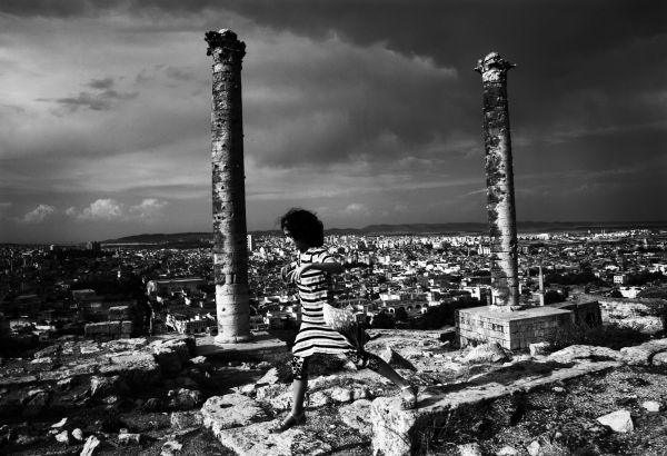 At the ruins of Sanliurfa Castle during Hittite era, a seemingly wealthy Muslim girl is chasing her parents. Sanliurfa, Turkey, July 26, 2007.