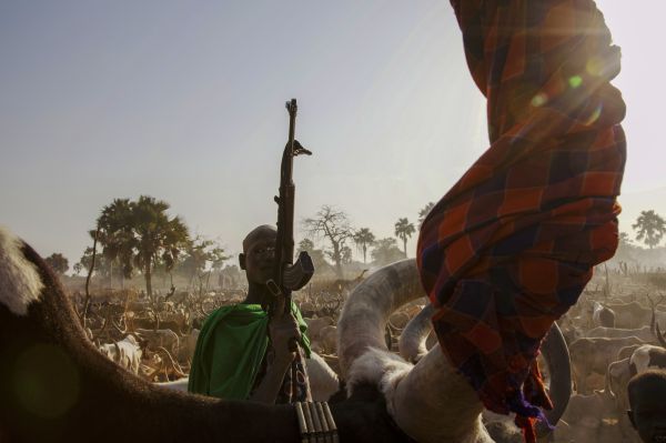 A cattle herder in Gun cattle camp poses with AK 47, as their disarmament becomes the critical issue in Southern Sudan.