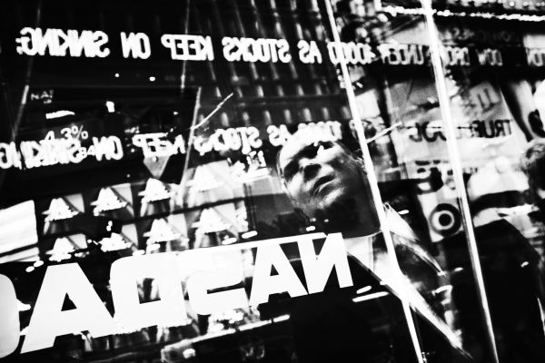 A man looks at the financial news with trepidation, at the Nasdaq stock-exchange site in New York City’s Times Square, as the world is facing the historic financial meltdown.