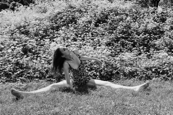 Rebecca, who nearly always needs a cane due to brain trauma injury and the permanent paralysis, though low level, relaxes on grass, in New York