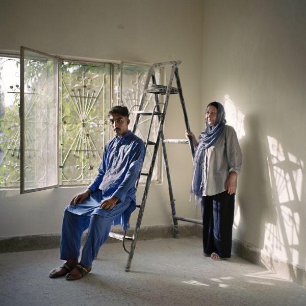 Abida Azadmanish, 54, an Afghan refugee in Islamabad, Pakistan, stands with one of her students, Abid Khan, 18, on July 10, 2018.
