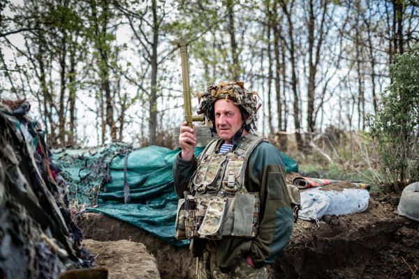A soldier holds a periscope at a Ukrainian army defense position in Horlivka, Ukraine. May 6, 2021.