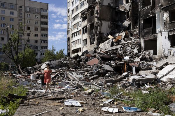 Ofeliia Yershova, 35 years old, examines the remains of a heavily damaged residential building in Kharkiv’s northern Saltivka neighborhood.
