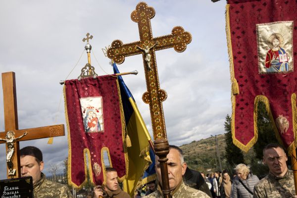 Ukrainian military personnel carry crosses and icons at the front of a funeral processions for Vasyl Pelish, who died in hospital at the age of 27 shortly after being severely wounded during intense fighting in eastern Ukraine’s Donbas region.