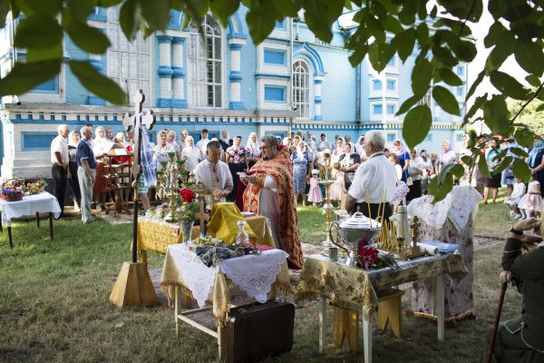 Father Ihor, a priest from the Ukrainian Orthodox Church Kyiv Patriarch, celebrates a mass on the holiday Spas outside of the Church of the Holy Dormition in the village of Ptycha.