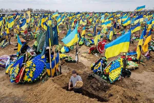 Oleksiy, 50 years old, digs a grave for a Ukrainian soldier from Kharkiv killed in the war in cemetery #18 on the southern edge of Kharkiv.