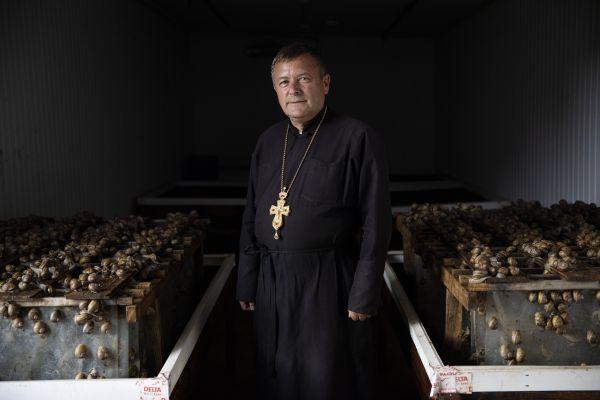 Father Vasyl Ivanyuk, a Ukrainian Greek-Catholic priest, stands next to several thousand snails at a snail farm called Zakhidniy Ravlik (Western Snail) in Solonka, a village located just south of the western Ukrainian city of Lviv.