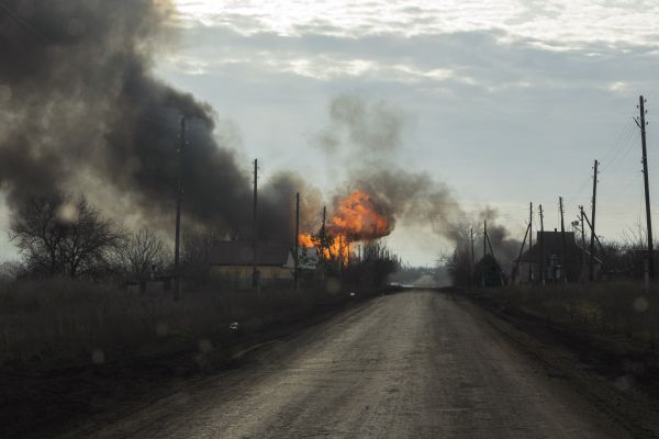 A Russian artillery shell explodes and destroys a house on the outskirts of Soledar in territory controlled by Ukrainian forces in eastern Ukraine’s Donbas region during a large artillery battle between Ukrainian and Russian forces.
