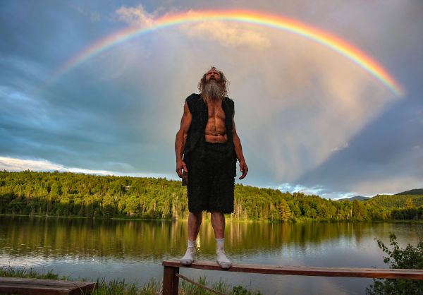 Tim Ryan looks around standing on the back porch of the cabin that he is living in after returning from work.