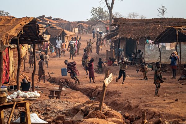 One of the main pathways in and out of PK3 IPD camp in Bria is full of activity at the end of a day.