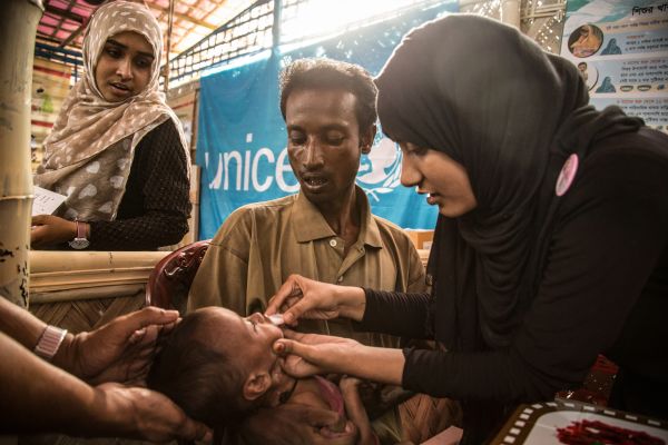 In a nutrition Centre in Balukhali Camp supported by Unicef and staffed by a Bangladeshi NGO health workers help father Mohammedd Said 32 care for his malnourished son Rashid, 18 months old and weighing only 4.65 Kg.