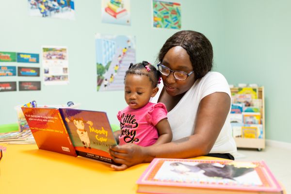 Tamia Armstrong reads to her 1 year old daughter Kinsley at the Mae Bertha Carter Learning Center in Drew, Mississippi.