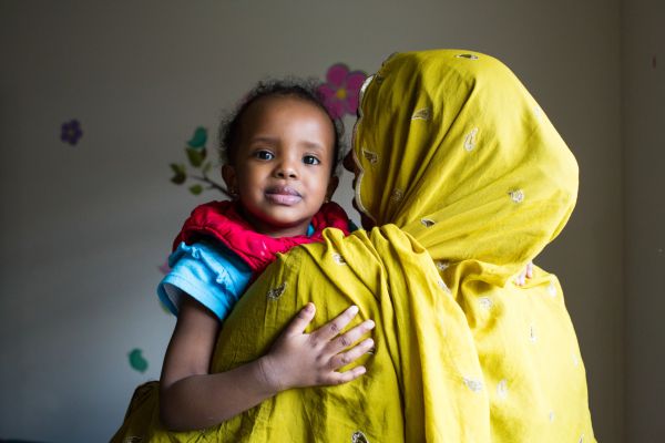 Hinda Ali, 2, hugs her mother Koos Husen at LiveWell Finney County Neighborhood Learning Center in Garden City, Kansas.