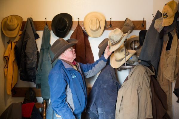 Gordon Jamison changes his hat at Jamison Cattle Ranch in Quinter, Kansas.