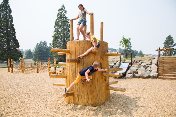 Kids playing at Kit Carson Park in Klamath Falls, Oregon during Park and Play, a program organized by the YMCA to provide daily lunch and activities at parks around the city.