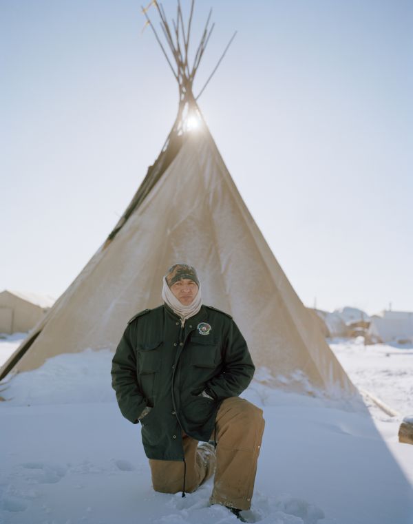 Lewis Grass Rope, a Lower Brule Sioux tribe member and one of the headsman at the Oceti Oyate “All Nations” Camp in front of his teepee which forms "The Horn" or the buffalo horns which point to the east to Washington, D.C.