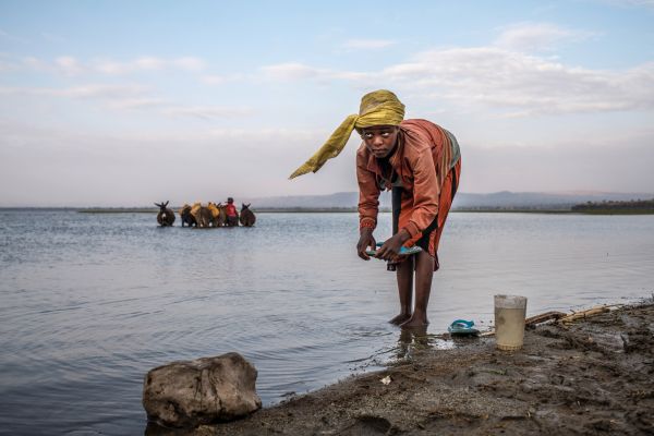 On the shores of Lake Hawassa, Ethiopia, people come at dawn to gather water and fish, on January 20, 2018.