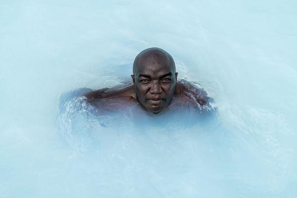 On a sunny afternoon an Olkaria engineer relaxes in the azure water of the Olkaria Geothermal Spa, which draws its mineral-rich water from condensed steam at the Olkaria geothermal power generation complex in Hells Gate National Park, Kenya, on August 18, 2018.