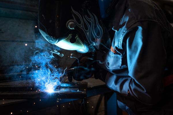 Mechanical engineer Monicah Mwalo welds metal together for the fabrication of parts for an electric vehicle conversion in Roam’s Research and Development unit in Nairobi, Kenya, on April 23, 2021.