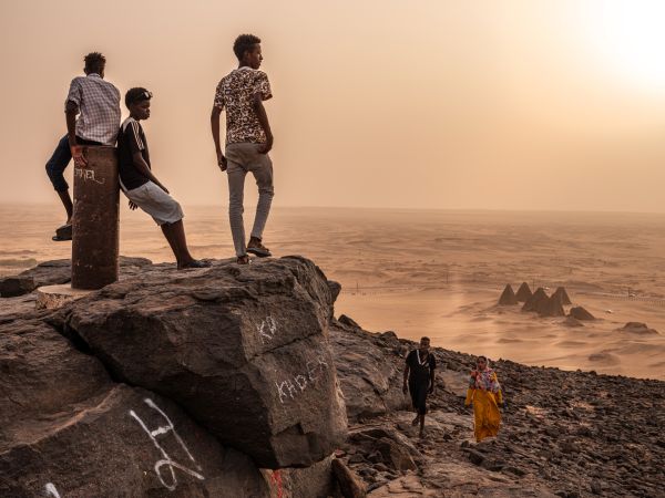 Sudanese tourists visit Jebel Barkal, Sudan, to climb the small butte that has been considered sacred for thousands of years, on August 1, 2021.