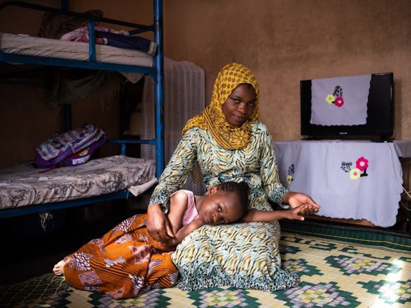 Portrait of Shakira Swalleh with her daughter Muhindo Shukri (6) in the living room of their home in Kampala, Uganda on March 9, 2022.