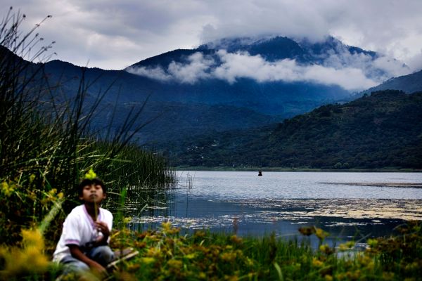 An Indigenous Guatemalan boy plays along the banks of Lake Atitlan on the day of national elections.
