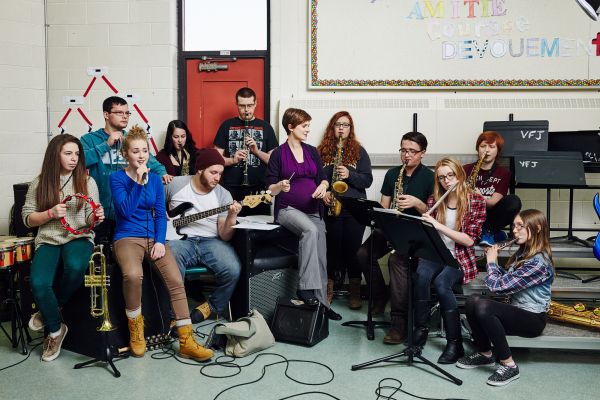 Dominique Hutchinson seated, teaching music class