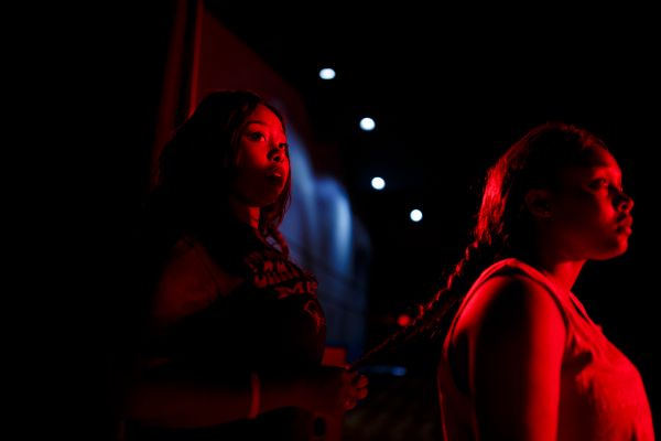 Junior Ayriel Ayers braids her Delta Sigma Theta sister Ricarnicea Johnson's hair during a sound check and performance run-through prior to the start of the Second Annual Chattanooga Black Greek Weekend Stepshow in Chattanooga, TN.