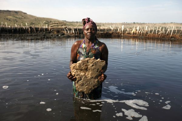 A salt worker holds a huge slab of salt she pulled out of Lake Katwe in Western Uganda.