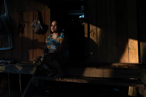 A Burmese migrant worker takes a rest after working all day in a rubber plantation.