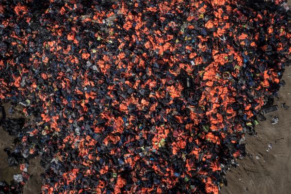 Over 100.000 lifevests and rubberboats lie in a almost 10 meter high pile on the island of Lesbos, Greece.