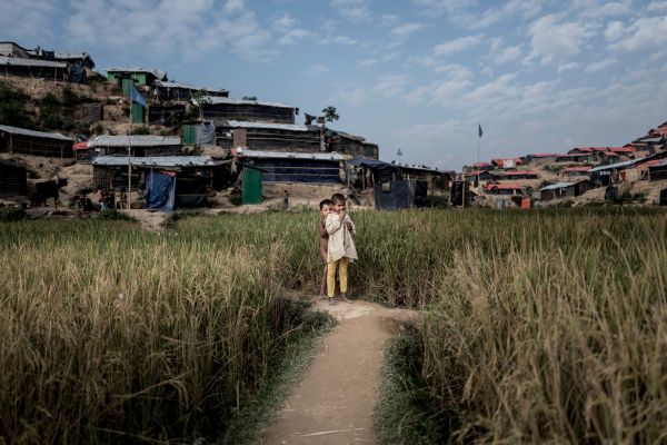 Two young Rohingyan girls play in the rice fields at Jamtoli refugee camp.