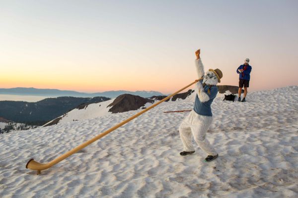 A woman dressed as a yeti, GU Energy Lab's mascot, blows an alpen horn at the top of the 3.8 mile climb where runners will summit at the start of the 100 mile Western States Endurance Run on Saturday, June 24, 2017 at Squaw Valley Ski Resort in Olympic Valley, CA.