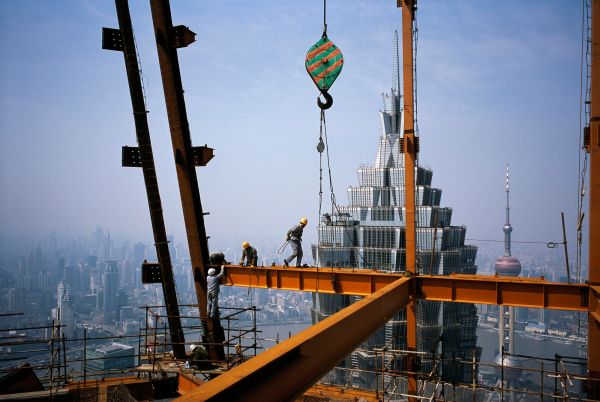 Construction workers set steel beams on the 88th floor of the Shanghai World Financial Center superstructure under construction in the Pudong New Area in Shanghai, China.
