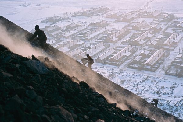 Desperate to heat their homes during the brutal winter, villagers in Qitaihe, China scale a mountain of slag to look for useable chunks of coal.