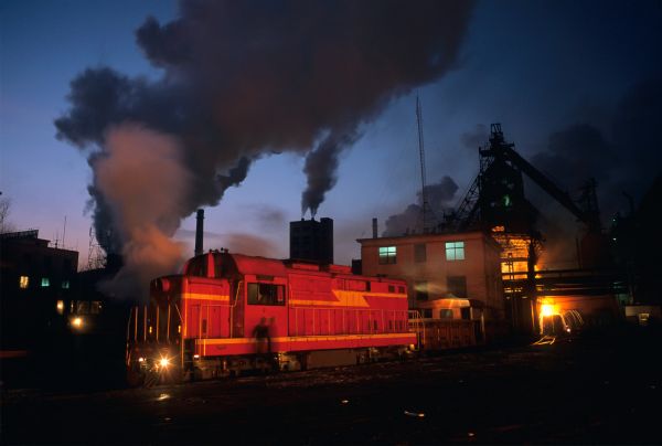 A steam engine connects to rail cars with buckets of molten iron at the state-owned Tonghua Iron and Steel, also known as TISCO, located in Tonghua, Jilin, China.