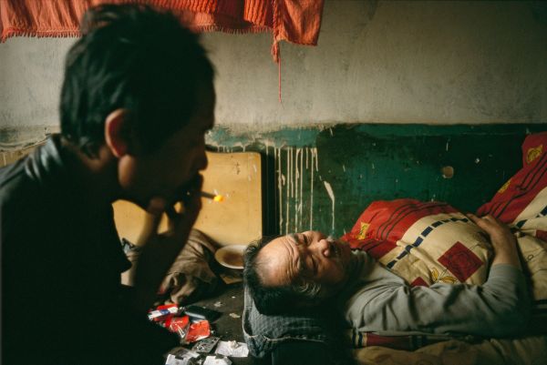 Bedridden from a stroke, Chen Guangxiao and his unemployed son, Lianshun, await the inevitable: eviction from the once-prestigious Model Workers Village in Shenyang, China's Tiexi Industrial District.