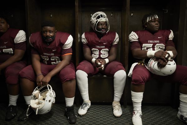 Dougherty High School Varsity Football "Trojans" Moments before the team's first game Ju-Marcus King #99 (center)  wait in  in the teams locker. They will be playing against the Turner County Rebels.